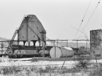 Engine maintenance facilities, always an opportunity !
<br>
<br>
 Especially old facilities. On dreary winter days.
<br>
<br>
Several TH&B units present including the GP- 7 #72 ( the future CP Rail #1682, retired 2011) coupled to GP- 9 #401 (the future CP Rail #1688, retired 2013 (!)) ; and right centre an unknown TH&B geep with an unknown GMD built CP Rail unit in the back ground.
<br>
<br>
No specific date for this black & white negative, a guess would be circa 1976 or 1977. I believe all the structures ( coal towers, fuel storage, and in the background the roundhouse ) shown here are history.
 <br>
<br>
B & W negative, at Hamilton,  by S.Danko.
<br>
<br>
Interesting:
<br>
<br>
Just envision – at one time – that the TH&B Aberdeen Yard was a prime candidate for an operational steam and rail museum given the  facilities: concrete (solid fuel) coaling towers, (liquid) fuel storage, turntable, brick roundhouse - Chatham Street ( demolished 1991) , mechanical shop(s), rail yard for storage, a  wye and most importantly a lightly used branch line (Waterford Subdivision) with a  westward grade to Summit, as well as access to a mainline with a heavy grade eastward up the escarpment. [ imagine a modern heavy Pacific (or  Northern (!)) tackling the Welland Subdivision eastward to Smithville ( then onto Dunnville branch ( the Erie & Ontario Railway))] !
<br>
<br>
More TH&B:
<br>
<br>
<a href="http://www.railpictures.ca/?attachment_id=7325">  westward  </a> 
<br>
<br>
<a href="http://www.railpictures.ca/?attachment_id=12998">  extra east  </a> 
<br>
<br>
<a href="http://www.railpictures.ca/?attachment_id=3102">  Shwa Turn </a> 
<br>
<br>
<a href="http://www.railpictures.ca/?attachment_id=16801">  great shot ! </a> 
<br>
<br>
sdfourty.
