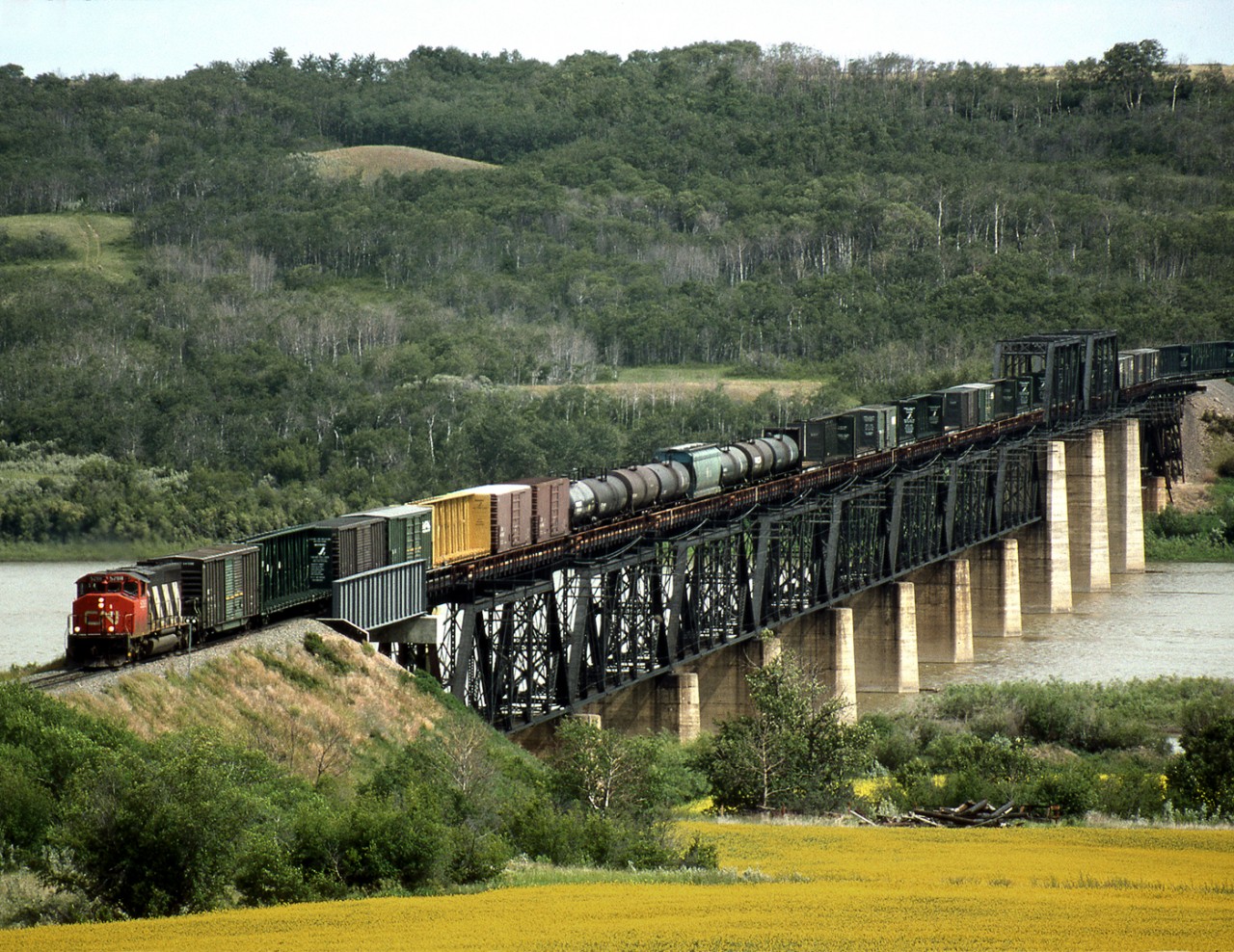 Westbound Train 359, Winnipeg to Prince George, operating on CN's secondary PNL line crosses the North Saskatchewan river just west of North Battleford.