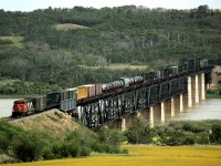 Westbound Train 359, Winnipeg to Prince George, operating on CN's secondary PNL line crosses the North Saskatchewan river just west of North Battleford. 