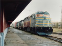 The Canadian American Railroad (CDAC) 450 leads this train slowing at the Sherbrooke station. This F40PHM-2 is the former Amtrak 380. Location is on Quebec Southern line, which extended from Ste. Jean to Lennoxville, just a throw down the road east of this image. This conglomeration of roads, former CP lines, commenced operations under the "Iron Road" blanket (which included Quebec Southern, CDAC, and Northern Vermont) in 1994 and became the Montreal, Maine & Atlantic in early 2003. Behind the 450 are leased HATX 419 and 420.
