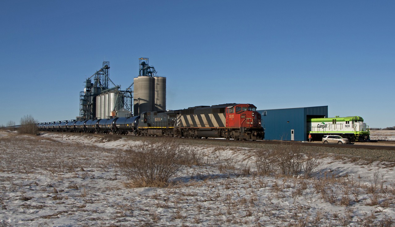 CN train U704 rolls past Cargill's newly acquired ex. BN C30-7
