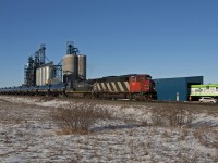 CN train U704 rolls past Cargill's newly acquired ex. BN C30-7