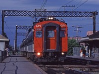 CN 6733 leads a string of MU cars making a station stop at Val Royal during the evening rush hour. 