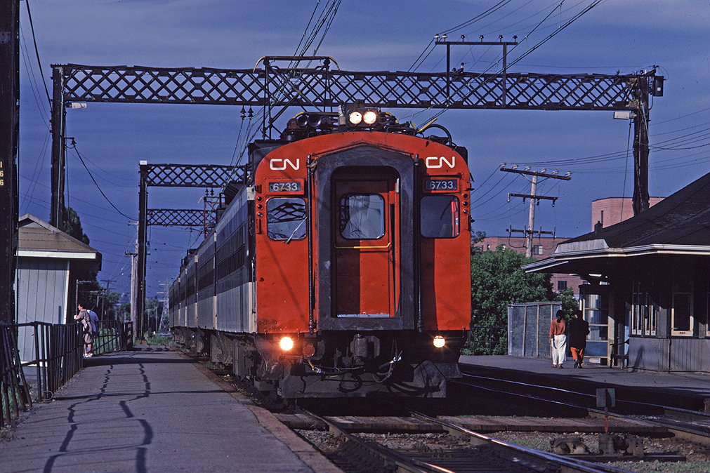 CN 6733 leads a string of MU cars making a station stop at Val Royal during the evening rush hour.