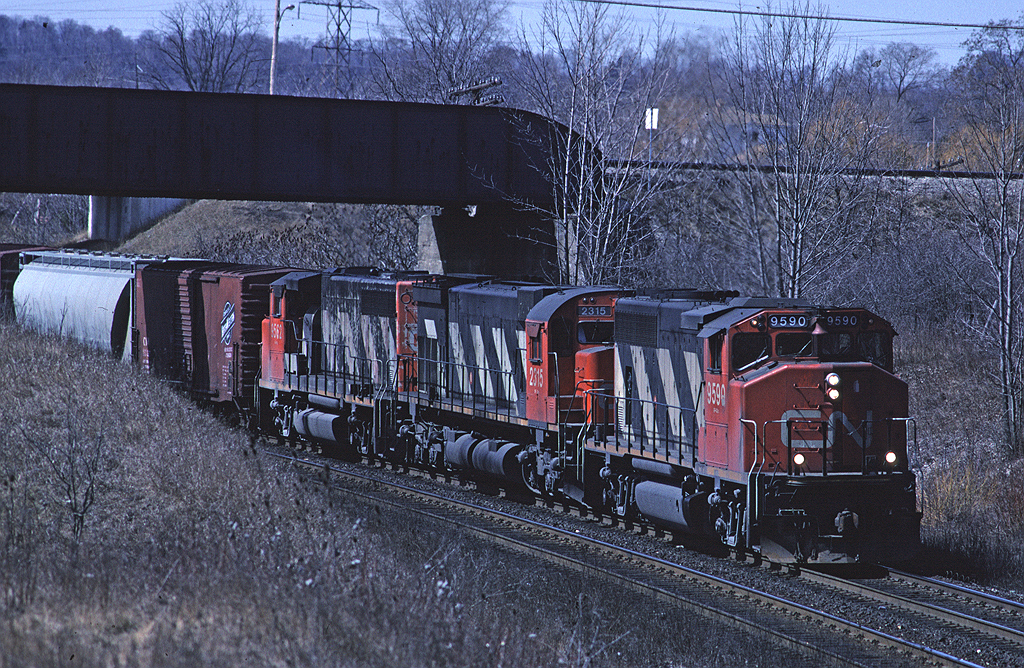 CN GP402W 9590 leads train #410 downgrade on the Dundas Sub passing under the CPR Hamilton Sub (I believe it was still the Goderich Sub at the time the photo was taken).
