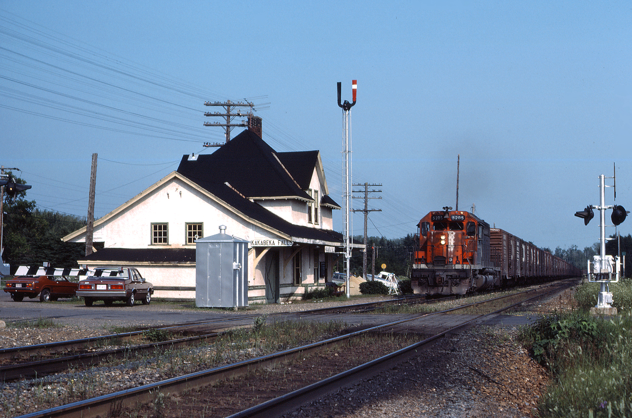 Extra CN 5205 leads an empty grain train past the classic station at Kakabeka Falls, still sporting a semaphore.  Kakabeka Falls is located at mile 22.5 on the Kashabowie Sub, which runs between Thunder Bay and Atikokan Ontario.