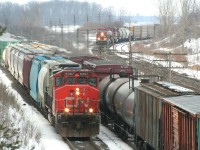 It's a busy moment for trains as all tracks are occupied. From left to right we have CN 534 with CN 5357 leading solo, a CN westbound mixed freight and CP 424 coming in on the CP line. 