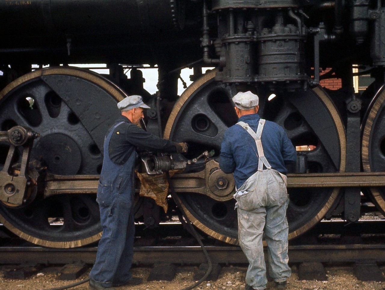 Bygone practice: the crew of Canadian National "Northern" 4-8-4 6167 attend to her drivers with grease guns and oil cans, lubricating bearings, rods and moving parts on the steam engine while stopped at Lindsay, Ontario on an excursion run.  According to Branchline magazine, this was the first winter steam excursion operated by the Upper Canada Railway Society, running from Toronto to Lindsay (via Blackwater Jct, on the Uxbridge Sub) on January 28th 1962.  Note: geotagged location not exact.