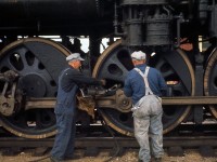 Bygone practice: the crew of Canadian National "Northern" 4-8-4 6167 attend to her drivers with grease guns and oil cans, lubricating bearings, rods and moving parts on the steam engine while stopped at Lindsay, Ontario on an excursion run. <br><br> According to Branchline magazine, this was the first winter steam excursion operated by the Upper Canada Railway Society, running from Toronto to Lindsay (via Blackwater Jct, on the Uxbridge Sub) on January 28th 1962. <br><br> <i>Note: geotagged location not exact.</i>