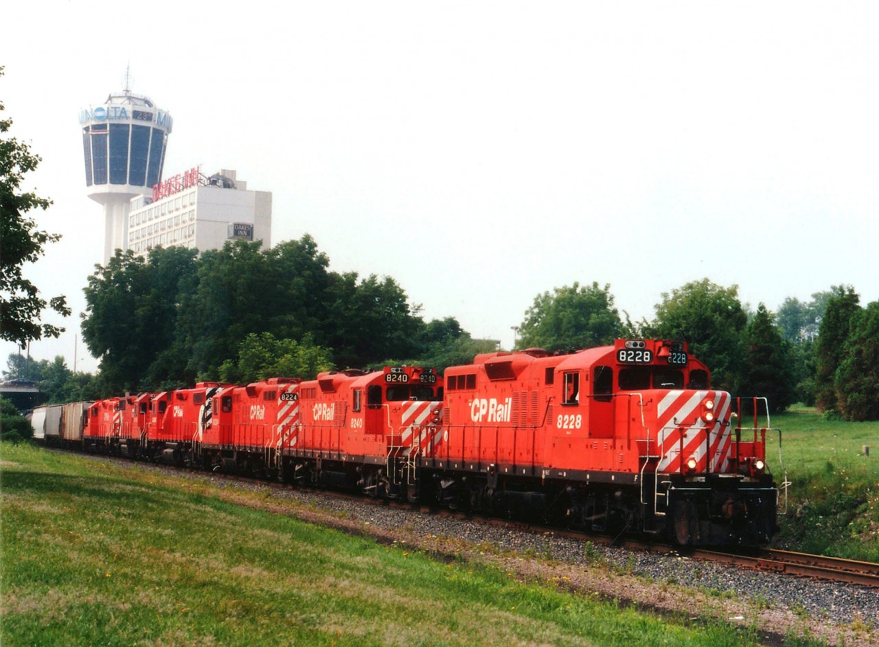 Back when CP trains to and from the US by way of Niagara Falls was commonplace, we see here a rather power-heavy #526; a Toronto to Buffalo train, rolling thru Queen Victoria Park. The Minolta Tower in the background is now the Skylon. Trains no longer traveled this route by early 1990, tracks taken up and valuable land used for construction of the massive Casino one sees there today. Mid-summer evening gave enough light for this lashup of CP 8228, 8240, 8224, 3060, 3119 and 8242 to be photographed. It was already past 8PM when the dispatcher was informed that 102 loads and 5 empties would be entering the United States. With several other trains doing this route daily, one has to wonder where all the traffic has gone..........