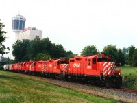 Back when CP trains to and from the US by way of Niagara Falls was commonplace, we see here a rather power-heavy #526; a Toronto to Buffalo train, rolling thru Queen Victoria Park. The Minolta Tower in the background is now the Skylon. Trains no longer traveled this route by early 1990, tracks taken up and valuable land used for construction of the massive Casino one sees there today. Mid-summer evening gave enough light for this lashup of CP 8228, 8240, 8224, 3060, 3119 and 8242 to be photographed. It was already past 8PM when the dispatcher was informed that 102 loads and 5 empties would be entering the United States. With several other trains doing this route daily, one has to wonder where all the traffic has gone..........