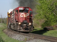 CP 5864 West is emitting some exhaust smoke as it hustles racks westward in the spring of 2008. The sound of the SD40-2s never fail to impress me.