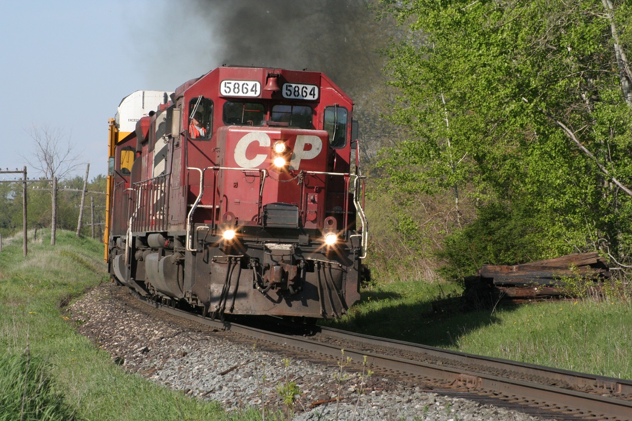 CP 5864 West is emitting some exhaust smoke as it hustles racks westward in the spring of 2008. The sound of the SD40-2s never fail to impress me.
