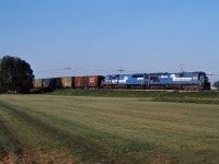 Conrail train CPSE, which typically ran on the CP, is seen here detouring on the CN through Brossard Quebec with Conrail 6598 and 6777 providing the power.  This train was detouring due to the Oka Crisis, which had the CP line shut down.