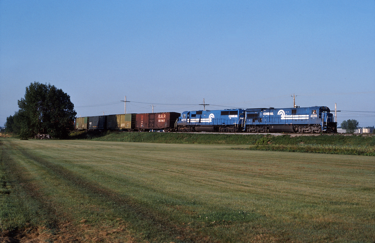 Conrail train CPSE, which typically ran on the CP, is seen here detouring on the CN through Brossard Quebec with Conrail 6598 and 6777 providing the power.  This train was detouring due to the Oka Crisis, which had the CP line shut down.