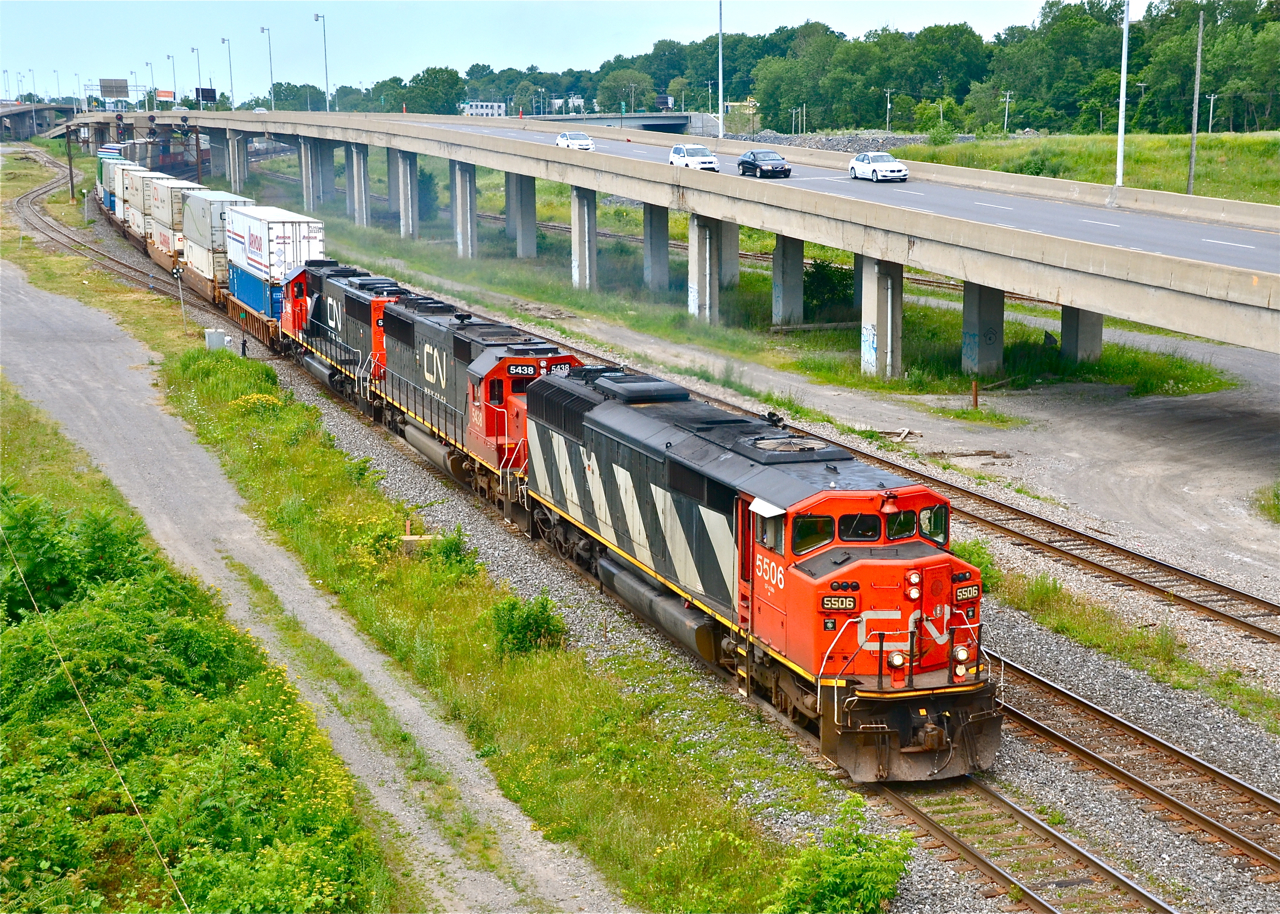 A late CN 120 with an incredible lashup of CN 5506, CN 5438 & freshly painted CN 5405 heads east.