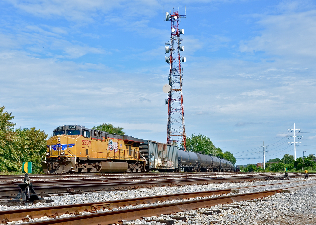 CP 608 (loaded oil train destined for Albany, NY) is passing CP's Lasalle yard with UP 5507 leading and another UP GEVO as the rear DPU (UP 5516). Visible in the far distance at the right is the tail end of CP 609, empties coming up from Albany.