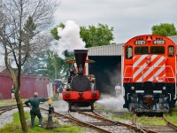 The John Molson steam engine has just been steamed up and is about to stretch its legs. It is passing CP 4563, an MLW M630.