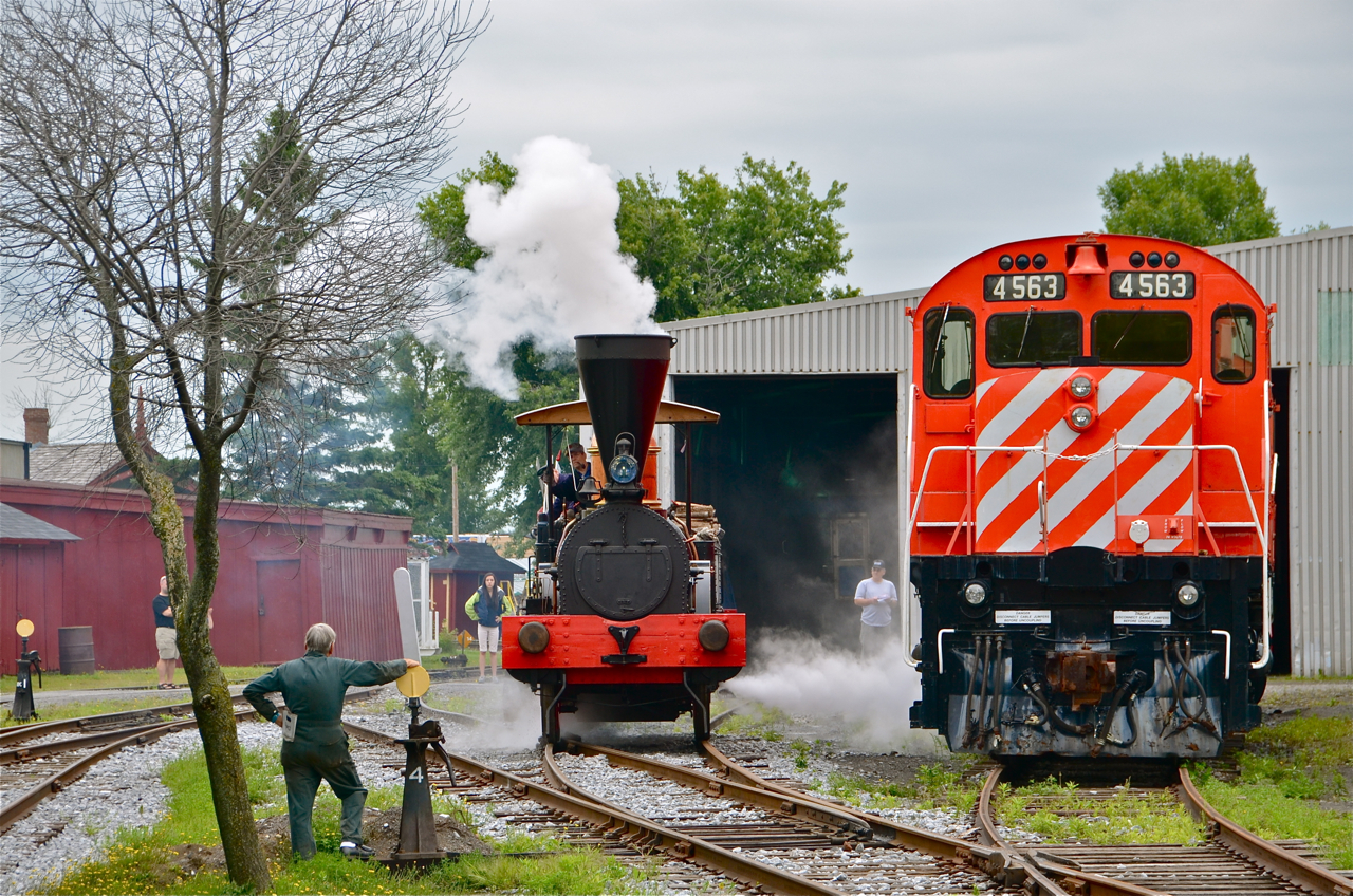 The John Molson steam engine has just been steamed up and is about to stretch its legs. It is passing CP 4563, an MLW M630.