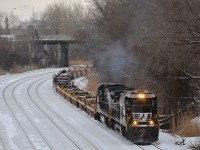 <b>Around the bend.</b> A transfer for the Port of Montreal with empty well cars heads east through Montreal West with a pair of NS standard cab GE's (NS 8821 & NS 8698). This power came in on CN 529. Sometimes CN 'borrows' the NS power durings its daytime layover.