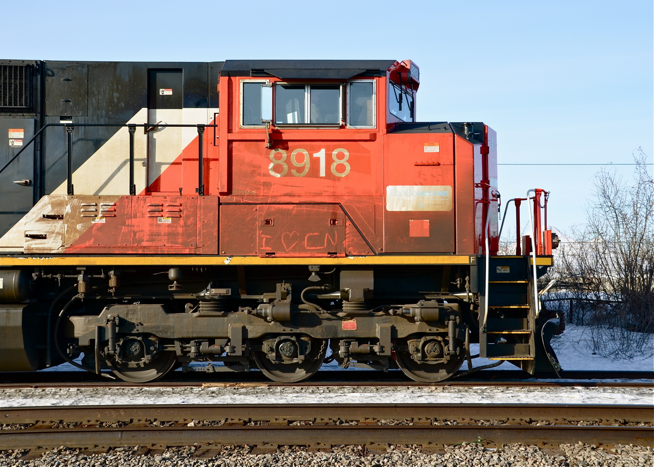 I heart CN Except Me! So says the message inscribed into the dirt on the cab of CN 8918 as it leads an eastbound through Dorval.