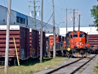 <b>Industrial switching.</b> A GP9-slug-GP9 trio (CN 7038, CN 221 & CN 7250) is busy moving cars on a siding off of the Côte De Liesse spur. This line is usually switched at night, so it was nice to run into this movement which was undoubtedly an extra.