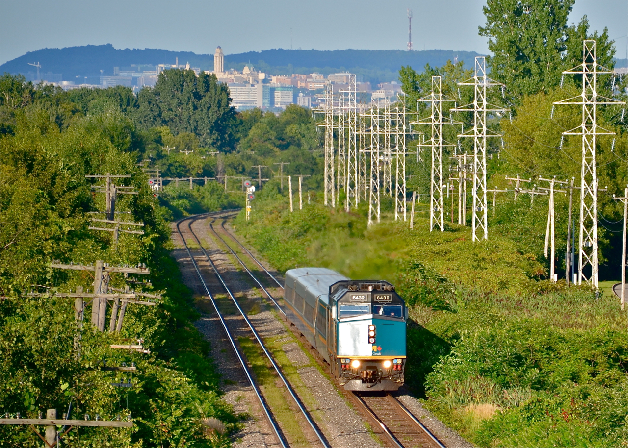 The mountain that gave Montreal its name. With Mount-Royal in the background, VIA 639 (bound for Ottawa) is heading through the Montreal suburb of Pointe-Claire on a beautiful summer evening with VIA 6432 in charge of four LRC cars.