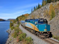 <b>Off the beaten path.</b> A rarely photographed but very scenic line which has almost no daytime traffic is CN's La Tuque Sub in northern Quebec. Here we see VIA 6440 leading VIA 604, the train from Senneterre past a very scenic rock cut at Lake Masketsi. In under half an hour it will be joined with VIA 600 from Jonquière at Hervey-Jonction and the combined train will head to Montreal, about an hour late.