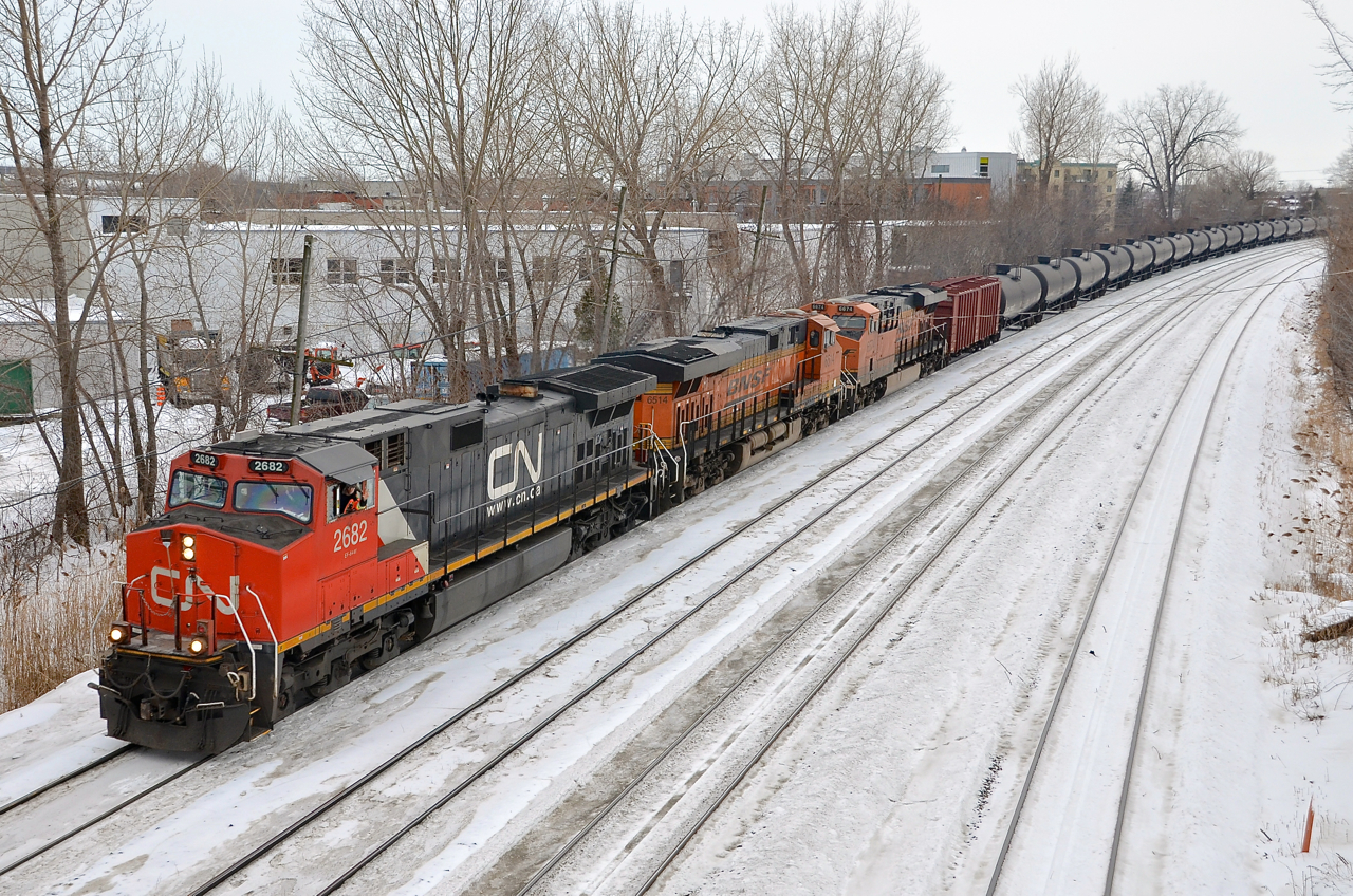 CN 710 with CN 2682, BNSF 6514 & BNSF 6674 heads east through Ville St-Pierre. It will stop at Turcot West in a couple of minutes to change crews before continuing on towards Joffre Yard. Waving is fellow railfan and recently qualified CN conductor Nicolas Houde.