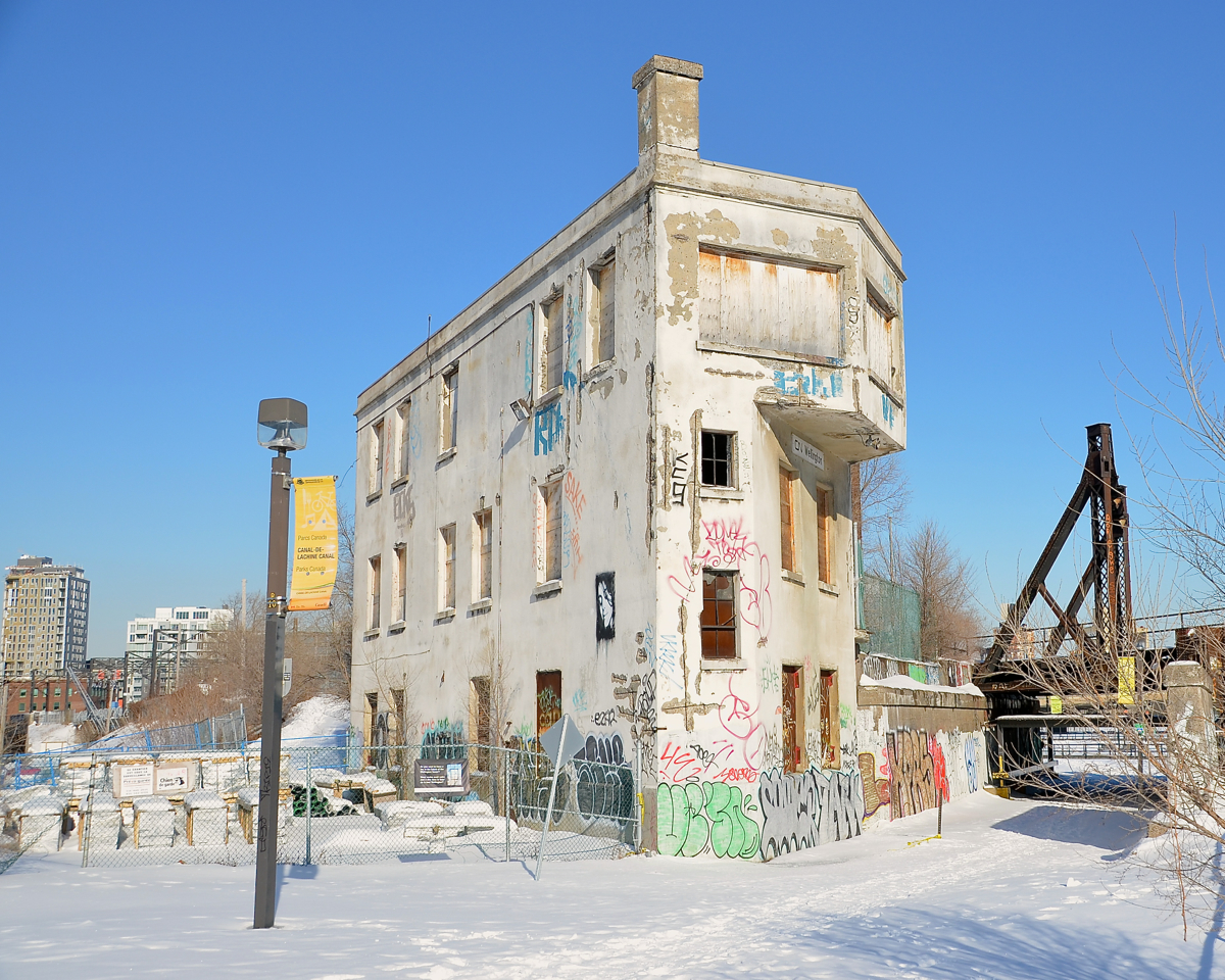 On a clear but cold day, the midday sun lights up the CN Wellington tower 1.05 miles south of Montreal's Central Station. In use until the early 2000's, it is now boarded up and out of use, though there has been talk about revitalizing it and putting it to use as a cultural centre. At right is the CN St-Hyacinthe sub, still busy with dozens of passenger trains a day.