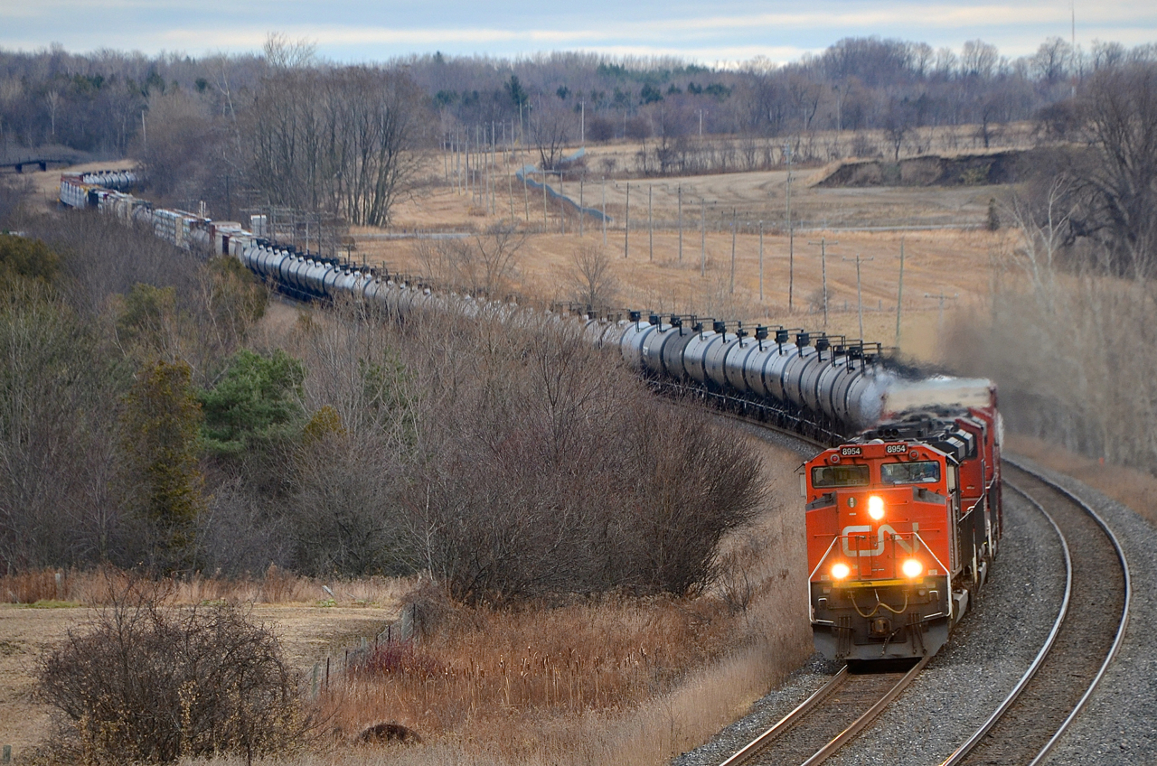 A trio of SD70M-2's (CN 8954, CN 8870 & CN 8016) negotiate the s-curve at Newtonville on an overcast day. Operating mid-train is CN 2693.
