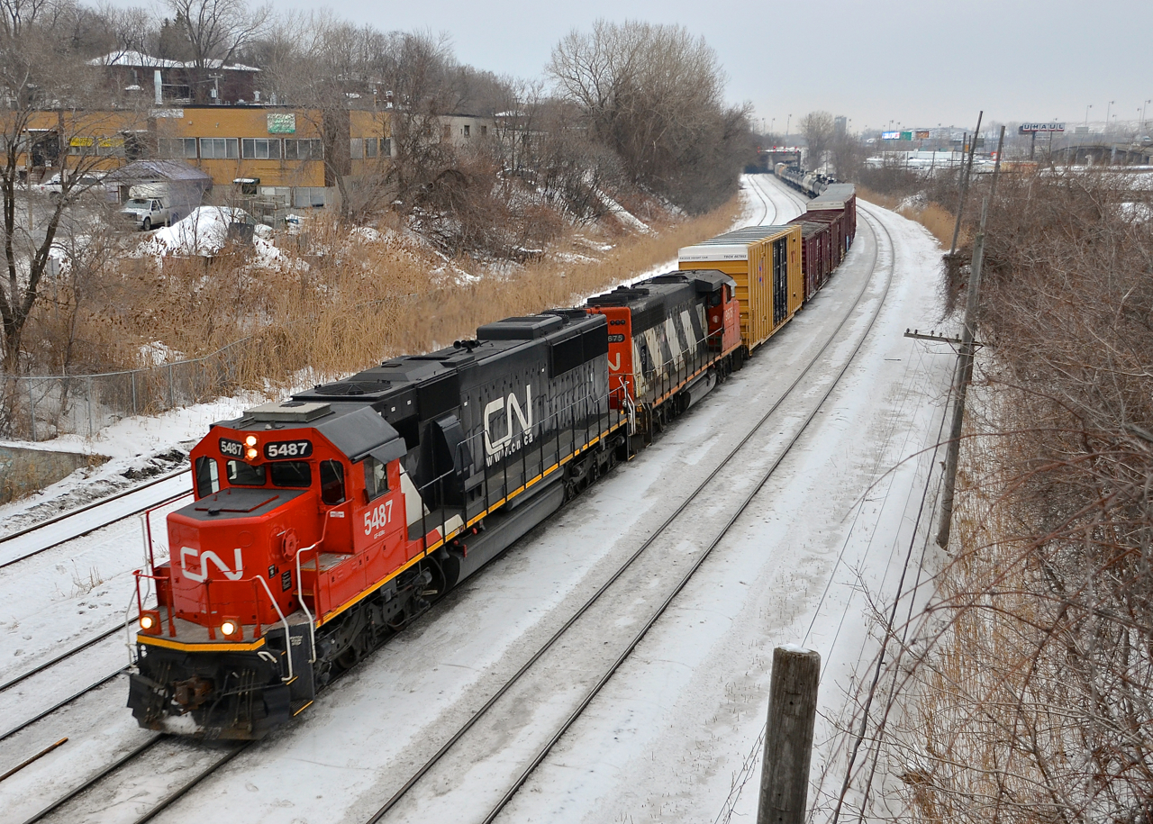 A longer than usual CN 323 (274 axles) is almost done for the day as it passes through Montreal West with CN 5487 & CN 9675 (ex-GOT 708).