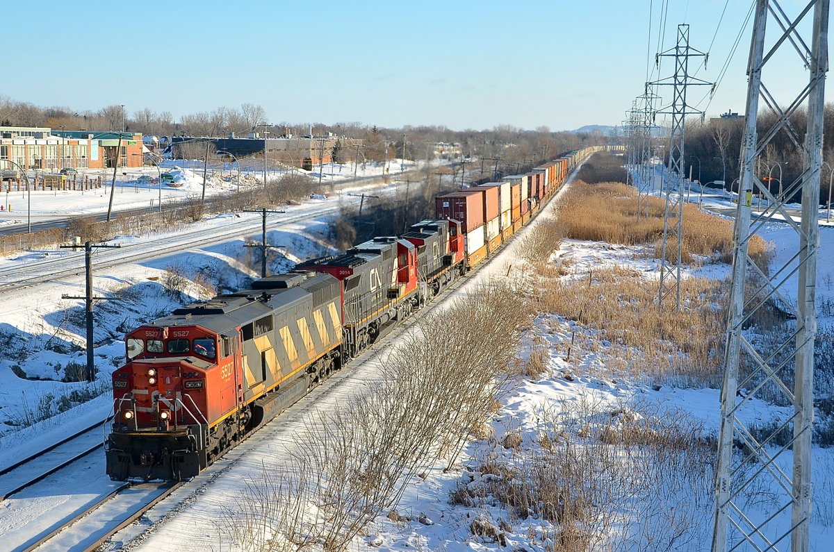 CN 149 heads west on the south track of CN's Kingston sub with an SD60F leading two GE's (CN 5527, CN 2014 & CN 2670). In a couple of minutes it will meet CN 310.