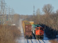 The tail end of CN 149 is passing the head end of CN 310 on CN's Kingston sub in Pointe-Claire. CN 310 has 8894 leading and another SD70M-2 mid-train (CN 8860).