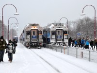 <b>Off to school.</b> AMT 41 (at left) and AMT 112 (at right) are both stopped at Montreal West station on a snowy morning and both are letting off students for nearby Royal West Academy. Most are inbound from the west island on 112 at right, but a few came from points east on 41. 