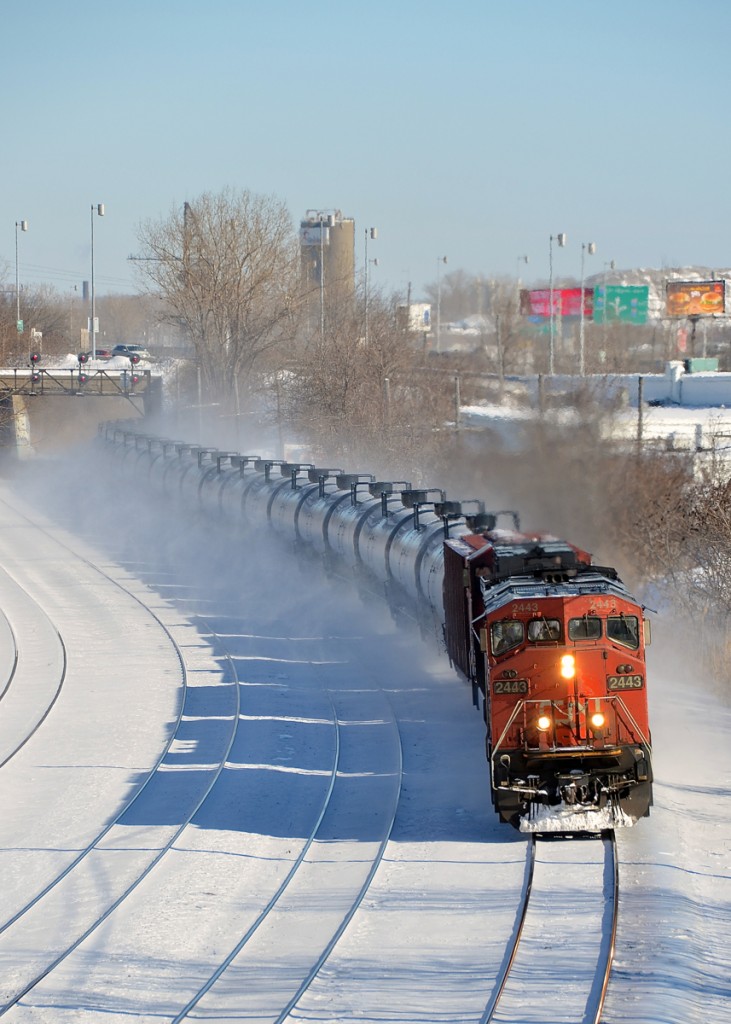 CN 711 speeds through Montreal West on the south track of CN's Montreal sub with CN 2443 leading.