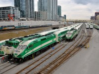 <b>Intruder!</b> All of the trains in this photo are GO Transit trains except for the VIA eastbound led by VIA 6443 which is passing the GO North Bathurst Yard which is filled with 6 trainsets between rush hours. Five are led by MP40PH-3C's while the sixth is led by an F59PH.