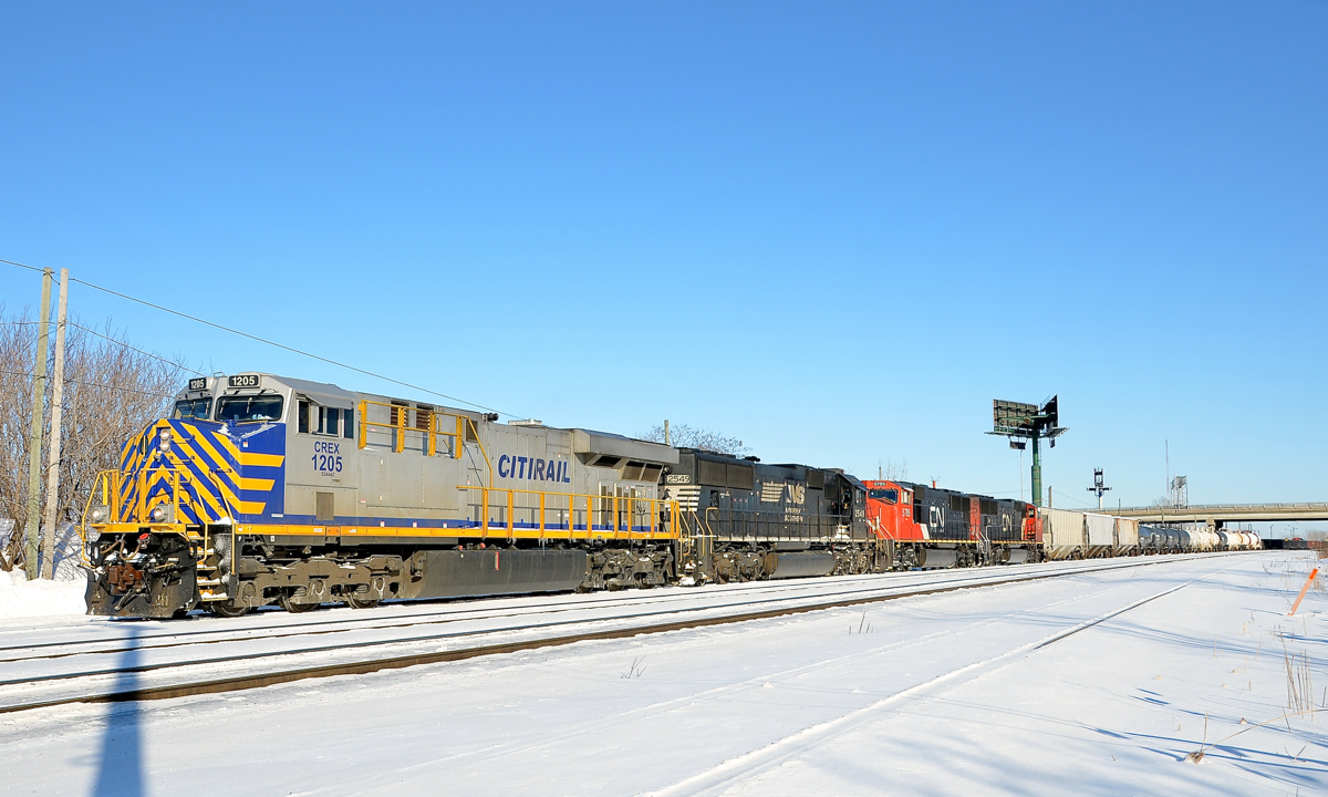 CN 527 is switching at the western end of Southwark Yard in St-Lambert with CREX 1205, NS2 549, CN 5875 & CN 5632. The last two units will head to Toronto on CN X321. The first two units will head to nearby Taschereau Yard with a local transfer (CN 527). The Citirail and NS units entered Montreal on CN 529 Friday morning. On Friday afternoon they left for Richmond, Qc on CN 394 and CN 393 only made it as far as Southwark yard before having to tie up, which explains why the power was in Southwark.