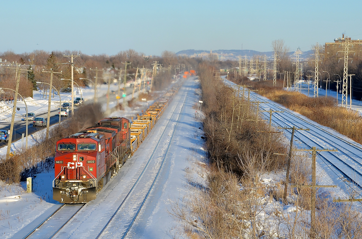 CP 143 heads west through Pointe-Claire with two CP AC4400CW's, CP 9822 and another unidentified unit.