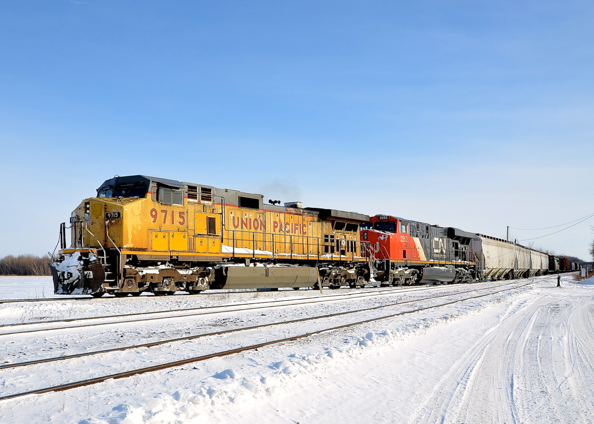 A ratty looking UP Dash9 (UP 9715) is teamed up with CN 2252 on CN 326 which is northbound on the Valleyfield sub. The train is on the wye towards the Kingston sub where it will back up its train into the Coteau Yard and do some work before continuing towards Montreal. This unit has been seen on CN 326 and CN 327 (which interchange with CSX at Huntingdon, Qc) a large number of times over the past six weeks.