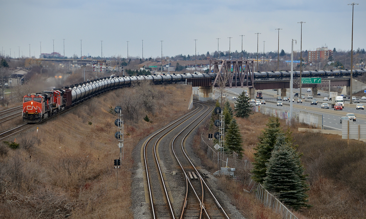 CN 2296 leads CN 710 on the last stretch of the York sub before it joins the Kingston sub (seen at the far left) at Pickering Junction. In the middle is the GO sub and at right is highway 401. Twenty minutes later CN 711 would pass in the opposite direction, preceded by CN 369.