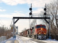 CN 394 with a pair of ES44DC's (CN 2239 & CN 2262) is passing a signal bridge at MP 70.30 of the CN St-Hyacinthe Sub with a fairly long train (about 110 cars). The train is just coming off of the Victoria Bridge, which is in the background. Behind me and out of sight is the St-Lambert station.