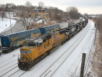 CN 529 is almost finished its trip from Rouses Point as it heads through Montreal West towards its destination of Taschereau Yard a few miles away. It is two days worth of CP 931's (CN picks it up from CP at Rouses Point, NY) and hence has four units rather than the usual two and 476 axles total (much heavier than usual). Power is a UP SD70M leading three NS units (UP 4875, NS 8868, NS 2778 & NS 9518). At left on the transfer track is a long cut of grain cars, perhaps an entire grain train. 