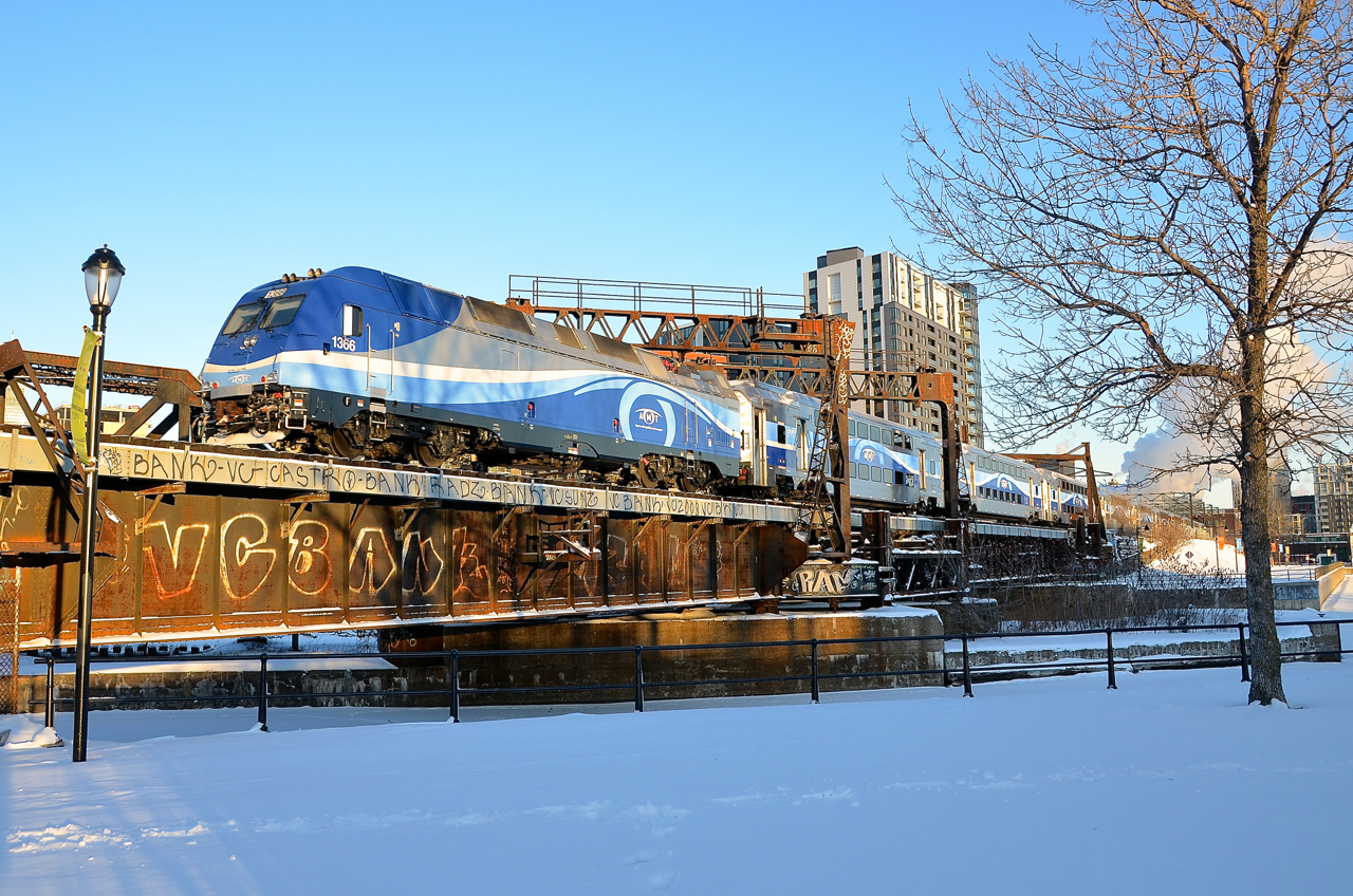 AMT 1366 is pushing AMT 807, inbound from Mont St-Hilaire, towards its 8:20 AM arrival at Montreal's Central Station. It is using a former lift bridge to cross the frozen Lachine Canal.