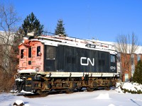 <b>Displayed near the end of the line.</b> CN 6710 was built by General Electric and delivered to the Canadian Northern as CNoR 600 in 1919. It was used on the Deux-Montagnes electrified line (which terminates nearby) until being retired in 1995. It is displayed in front of the Deux-Montagnes station, which still sees electric trains, but not locomotive hauled. This may change if AMT's new dual-mode engines are finally used on this line.