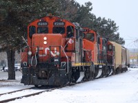 IOX returns from the grain elevator in Sarnia with CN7265, CN4777, CN7039 and three hopper cars. Meanwhile to the left CN Police hand out a ticket to a motorist running the red signals.