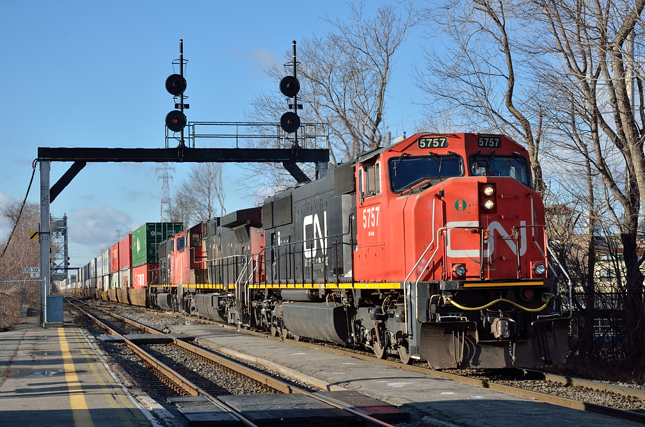 CN 120 exits the Vitoria Bridge and passes St Lambert station on its way east to Joffre, Moncton and Halifax on the last day of 2014.