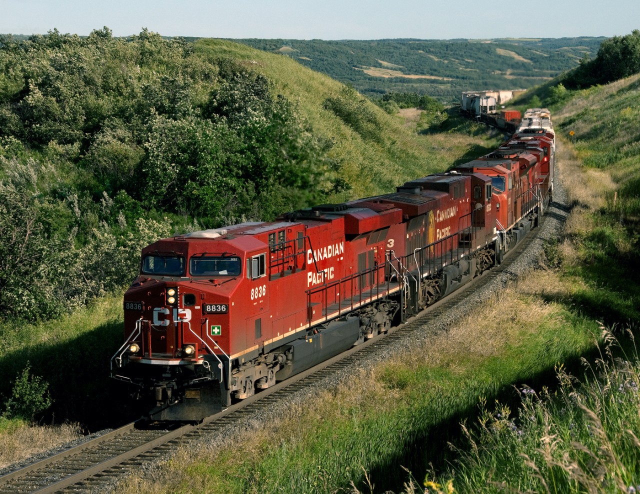 Westbound freight on CP's north main across the prairies climbs Harrowby hill out of the Assiniboine valley near the Saskatchewan boundary on the Bredenbury Subdivision nicknamed Manitoba's mountain railroad with grades, some over 2 pc, out of the Little Saskatchewan, Birdtail and Assiniboine Valleys