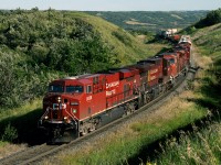 Westbound freight on CP's north main across the prairies climbs Harrowby hill out of the Assiniboine valley near the Saskatchewan boundary on the Bredenbury Subdivision nicknamed Manitoba's mountain railroad with grades, some over 2 pc, out of the Little Saskatchewan, Birdtail and Assiniboine Valleys 