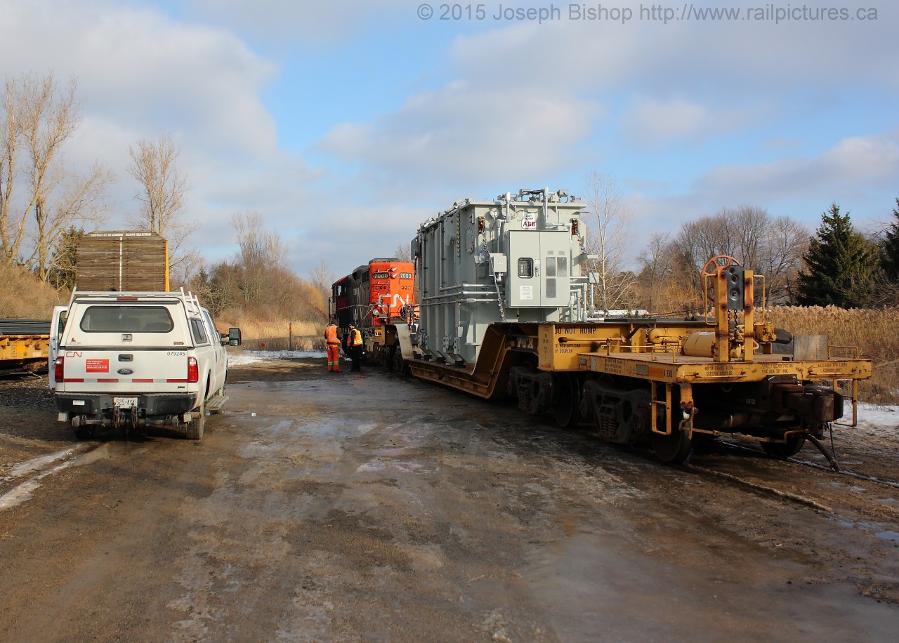 Rare Move  CN L58031-23 is seen spotting a large transformed on the rarely used siding in Copetown Ontario.  The crew had to position the car above the large concrete pad to allow for offloading at a later time.  Having seen 580 lined up the South Track from Bayview I was expecting to find a stalled freight here, but this was a pleasant surprise!